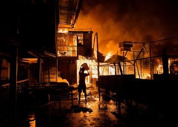 fire destroys a building, leaving people homeless