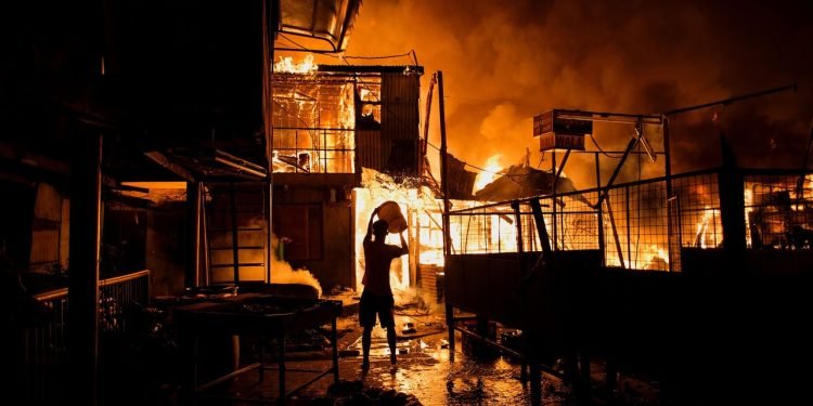 fire destroys a building, leaving people homeless